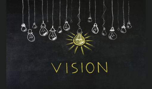 Lightbulbs on a blackboard with the word vision in yellow