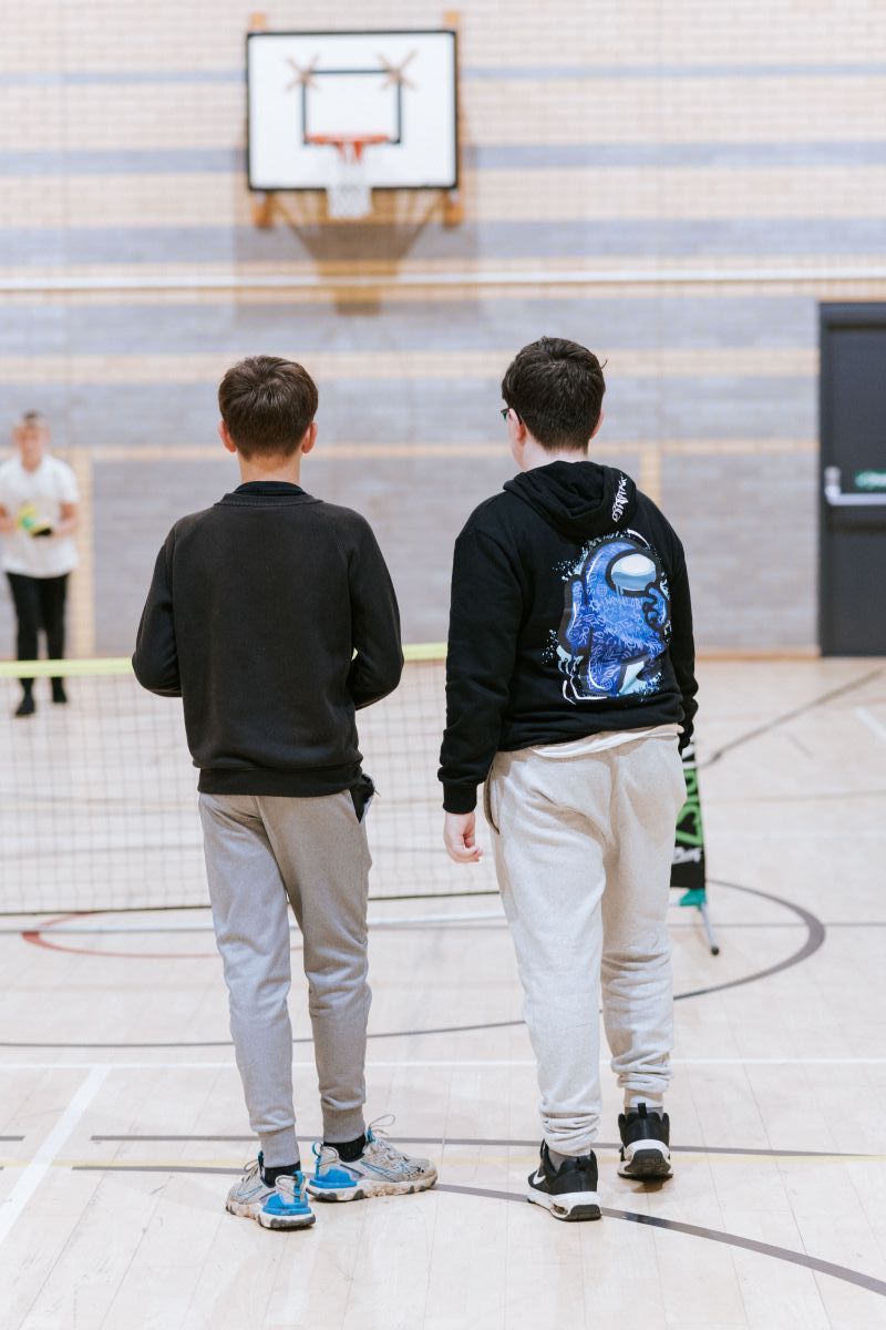 Students in the gym playing team ball games